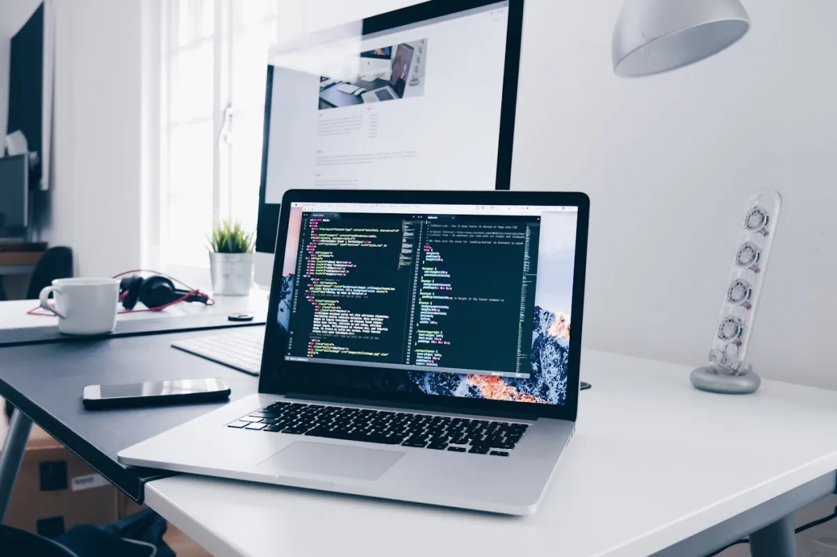 Website development workspace with code displayed on a laptop